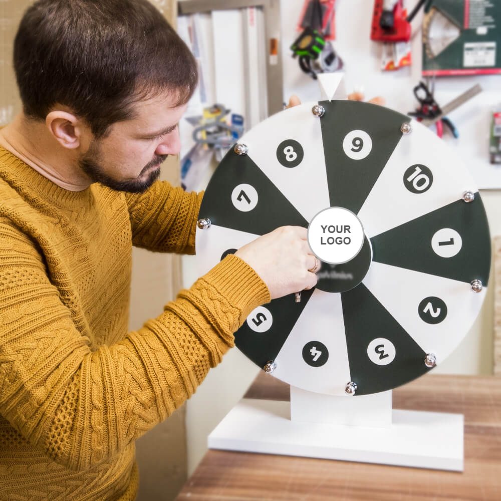 Craftsman assembling a black and white prize wheel of fortune