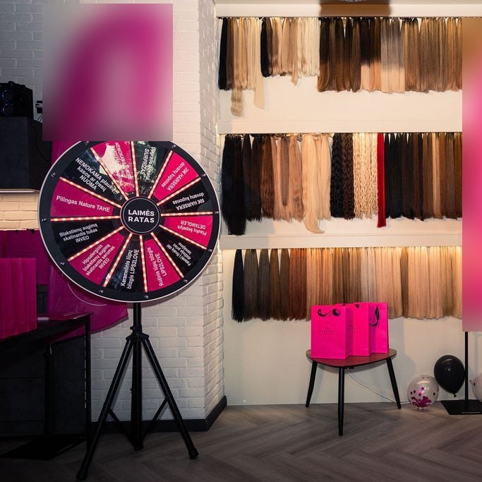 Prize wheel of fortune on a tripod stand at a beauty salon launch event